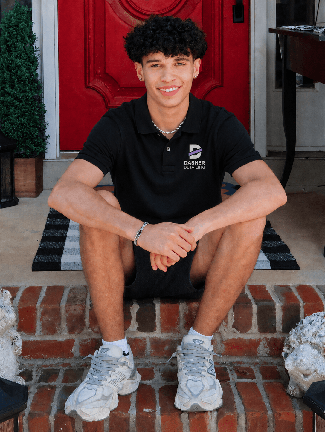 Asher, owner of Dasher Detailing, in a branded polo outside his home in Wake Forest, NC